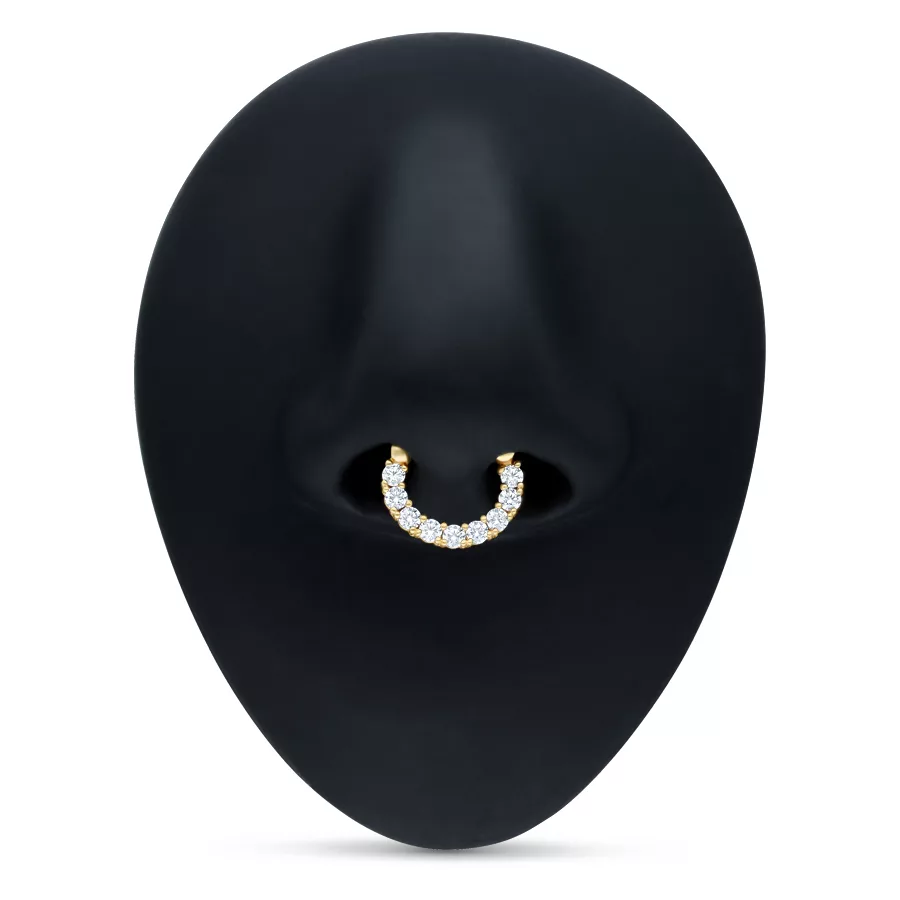 Goldener Septum Clicker mit klaren Kristallen auf schwarzem Hintergrund