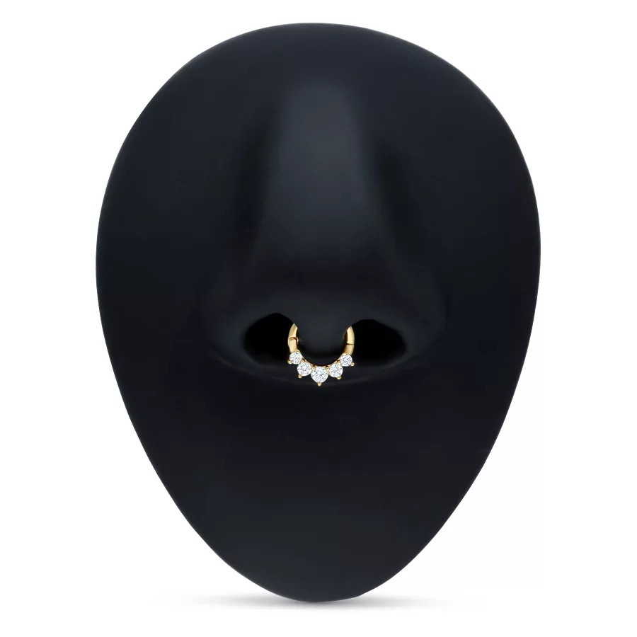 Goldener Septum Clicker mit klaren Kristallen auf schwarzem Hintergrund