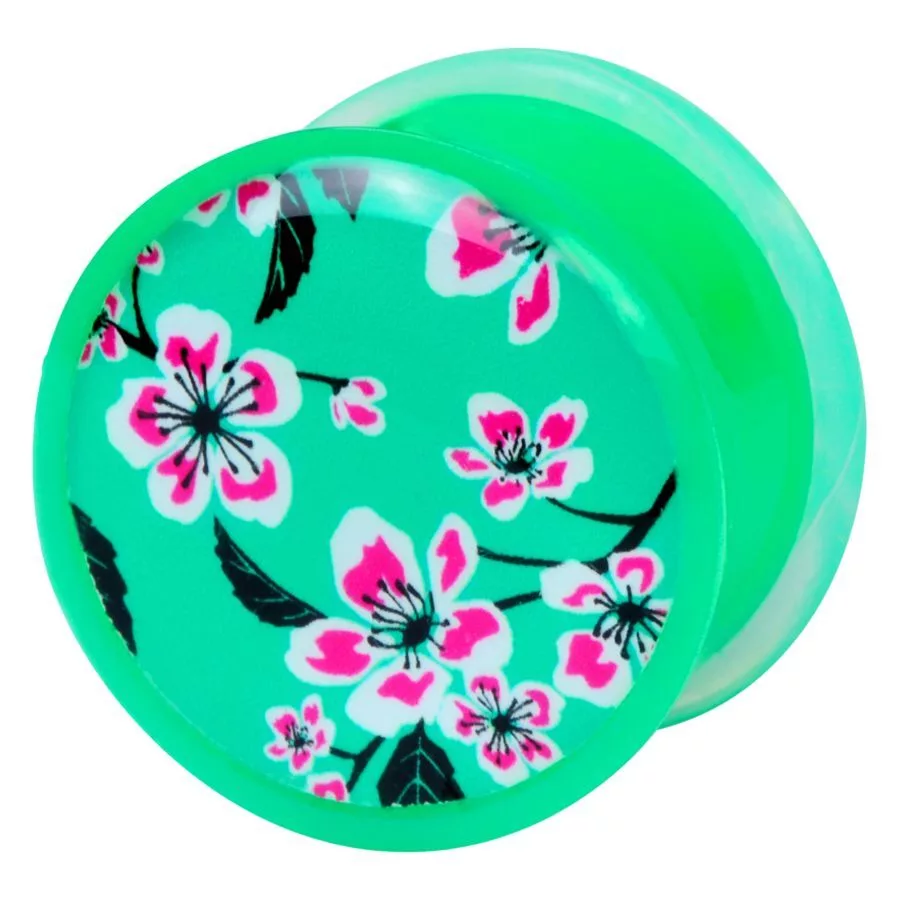Blumen-Plug grün mit rosa Blüten Grüner Plug mit rosa Blumenmuster auf weißem Hintergrund