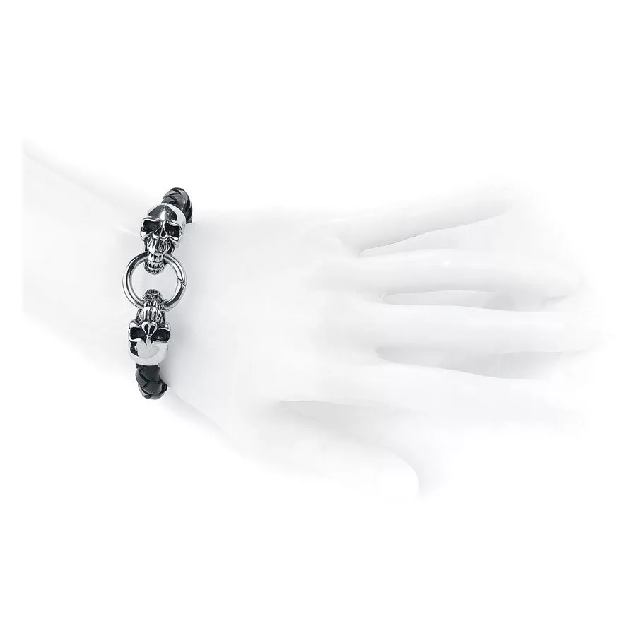Schwarzes Lederarmband mit Totenkopfdetails Armband aus schwarzem Leder mit silbernen Totenköpfen auf einem weißen Handmodell