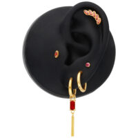 Goldene Ohrringe mit Siam-Kristallen Goldene Creolen mit rechteckigem Siam-Kristall an schwarzem Ohrmodell