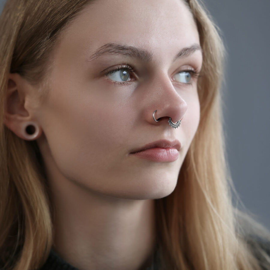 Frau mit silbernem Septum Clicker von Wildcat, grauer Hintergrund