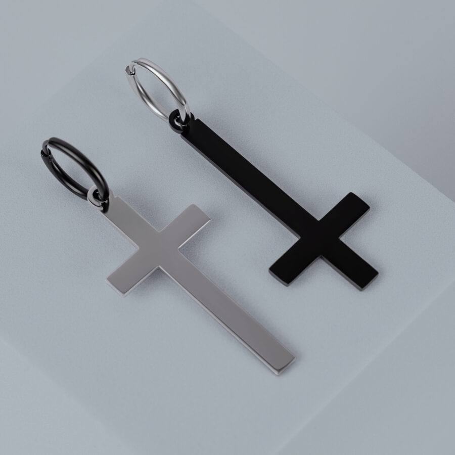 Zwei Kreuz-Ohrringe aus Chirurgenstahl in Gold und Schwarz auf grauem Hintergrund
