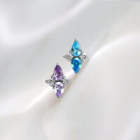 Push Fit Crystal Harmony Aufsatz Lavendel & Türkis Zwei Push Fit Aufsätze aus Titan in Lavendel und Türkis auf weißem Hintergrund