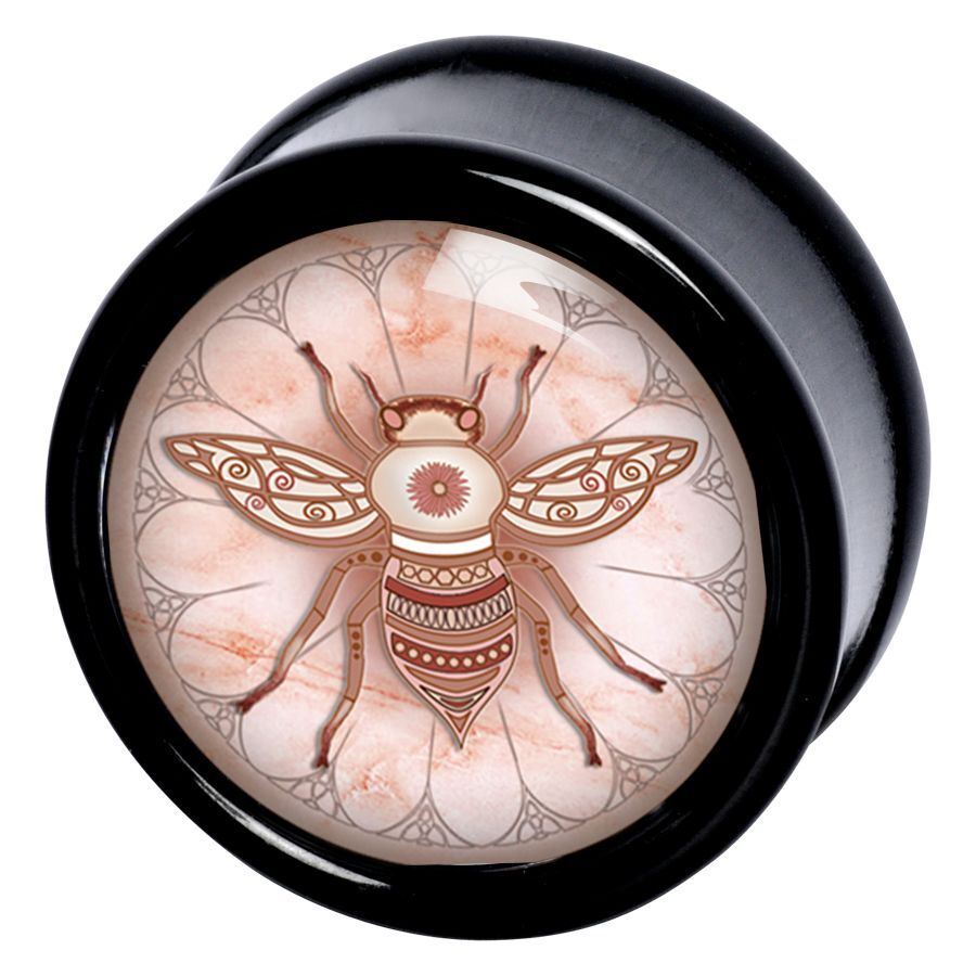 Runder schwarzer Plug mit Bienenmotiv und Ornament auf hellem Hintergrund