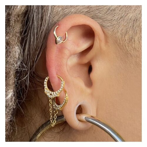 Goldene Helix-Piercings am Ohr mit kurzen Ketten und funkelnden Steinen