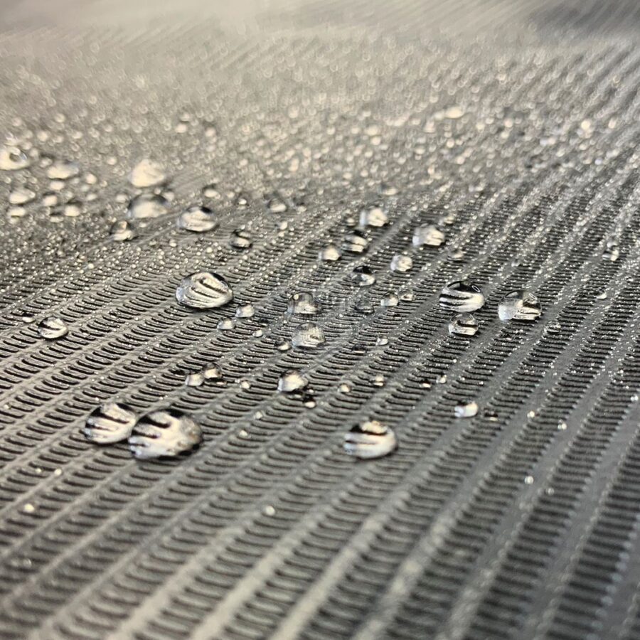 Nahaufnahme einer schwarzen, wasserdichten Abdeckrolle mit Wassertropfen