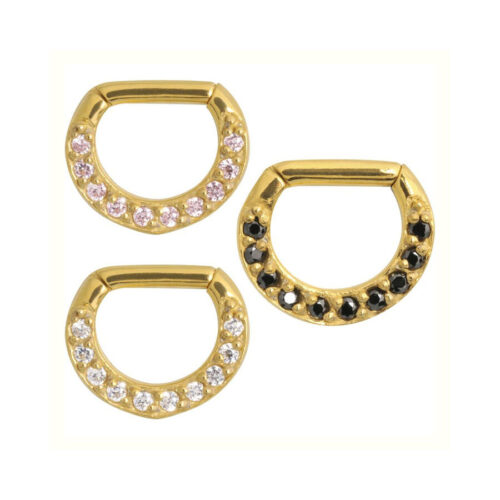 Drei goldene Septum Clicker mit schwarzen und klaren Kristallen auf weißem Hintergrund
